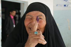 Female voters display their purple finger tips after casting ballots at an elementary school in Nasiriyah March 7. By law, women must fill 25percent -- 82 out of the 325 -- parliamentary seats. The heavy purple dye reduces attempts of double-voting fraud. No election day violence occurred in Nasiriyah, Iraq's fourth largest city bisected by the Euphrates River in the southern province of Dhi Qar. Iraqi security forces were responsible for all security.